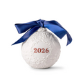 White ornament with '2026' and a blue ribbon on a white background