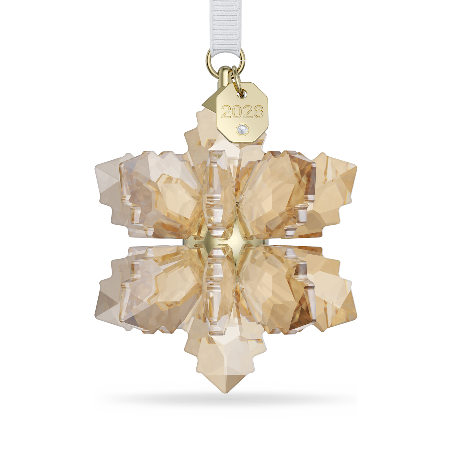 A faceted snowflake-shaped crystal ornament in a warm champagne gold tone, suspended from a white ribbon with a gold tag engraved with '2026'.