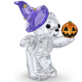 A clear faceted crystal bear figurine wearing a purple witch hat and holding a small orange jack-o'-lantern pumpkin, shown on a plain white background.