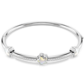 A polished silver bangle bracelet featuring a central silver flower charm with a white inlay, accented by small clear stones along the band, set against a plain white background.