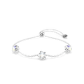 A delicate silver chain bracelet with three star-shaped charms, two of which are adorned with small blue stones, displayed on a clean white background.