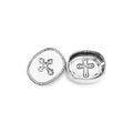 Silver trinket dish with starfish and cross designs on a white background