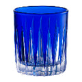 Blue glass tumbler with textured design on a white background