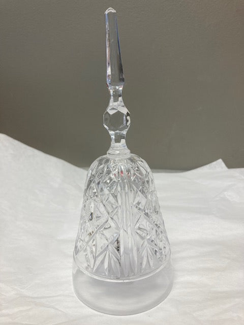 Crystal wine glass with a long stem on a white fabric background