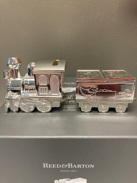 Set of silver and crystal containers with Reed & Barton branding on a gray background