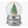 A Christmas-themed snow globe music box featuring a green decorated tree, colorful ornaments, gifts, and falling snow inside a clear globe on an ornate silver base.