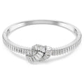 Diamond ring with a central gemstone and baguette-cut diamonds on a white background